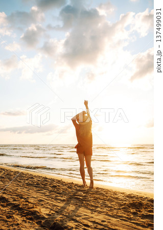 Beautiful woman enjoying a summer day on the beach at sunset. Lifestyle, tourism, active life. Beautiful woman enjoying a summer day on the beach at sunset. Lifestyle, tourism, active life. 137499031