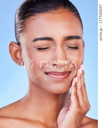 Toothache, sad and a woman with mouth pain on a blue background with a dental emergency. Dentist, frustrated and a girl with a problem with a teeth injury, gingivitis or inflammation of a gum 137500047