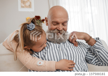 Love, couch, and child hug grandfather in a home for bonding, care and relax together in living room for fun. Senior, sofa and elderly person or grandparent with girl kid as family on retirement 137500181