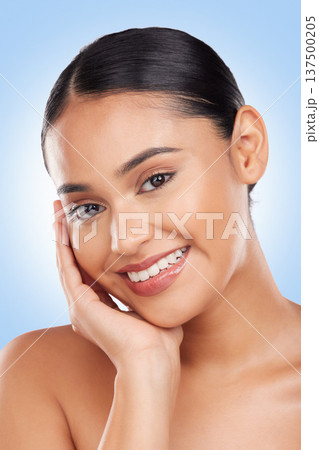 Beauty, makeup and happy with portrait of woman in studio for cosmetics, glow and self care. Health, skincare and dermatology with face of person on blue background for facial, salon and cosmetology 137500205