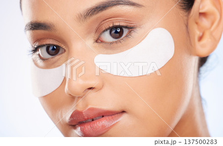 Portrait, skincare and woman with eye patch for anti aging or skin glow for beauty on studio background. Cosmetics, facial detox and face of model with pads or collagen mask for dermatology product. 137500283