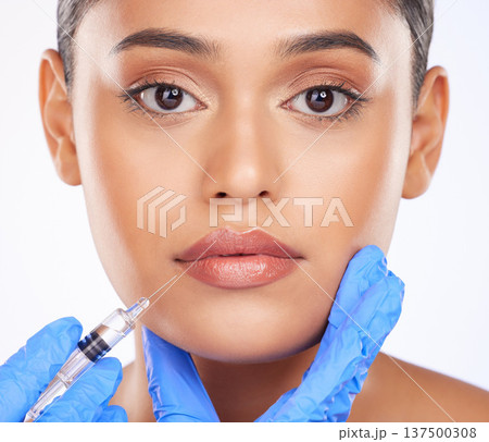 Face, lip filler and dermatology, woman and beauty with doctor and plastic surgery on white background. Portrait, cosmetic treatment and liquid collagen, needle syringe and wellness in a studio Face, lip filler and dermatology, woman and beauty with doctor and plastic surgery on white background. Portrait, cosmetic treatment and liquid collagen, needle syringe and wellness in a studio 137500308
