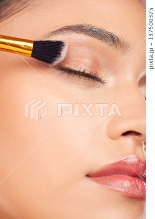 Makeup brush, eyes closed and face of woman with eyeshadow product, cosmetics shine and beauty care tools. Foundation application, anti aging treatment and studio closeup of relax skincare model Makeup brush, eyes closed and face of woman with eyeshadow product, cosmetics shine and beauty care tools. Foundation application, anti aging treatment and studio closeup of relax skincare model 137500375