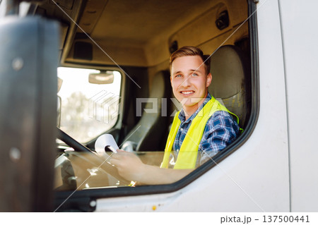 Truck driver job. Logistics - proud driver or forwarder on truck and trailer, on transshipment point 137500441
