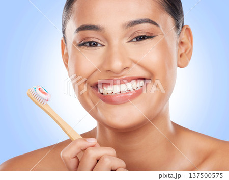Happy portrait, woman and toothbrush on blue background for dental cleaning, gingivitis and beauty in studio. Model, toothpaste and brushing teeth with bamboo for oral hygiene, healthy smile and care 137500575