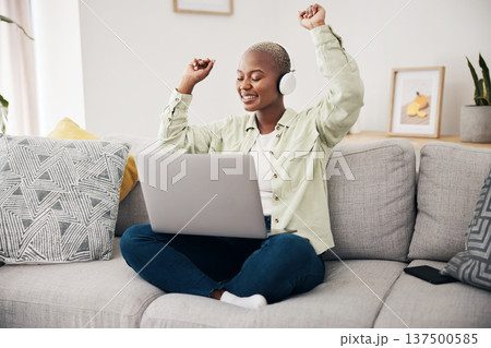 Music, dance and black woman with laptop on sofa with headphones, happy and free at home. Radio, earphones and African female dancing to online feel good podcast in living room smile for subscription Music, dance and black woman with laptop on sofa with headphones, happy and free at home. Radio, earphones and African female dancing to online feel good podcast in living room smile for subscription 137500585