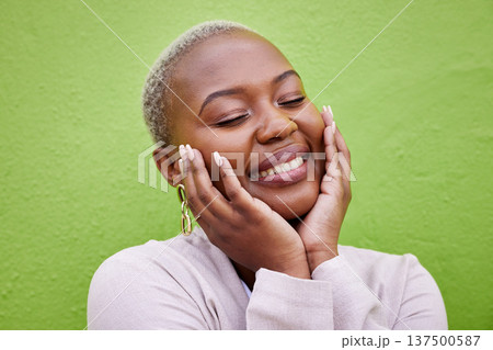 Laughing, black woman and self love or pride on a green wall for fashion, thinking or trendy. Smile, young and a calm African girl or fun model with confidence, fashion or peace on a background Laughing, black woman and self love or pride on a green wall for fashion, thinking or trendy. Smile, young and a calm African girl or fun model with confidence, fashion or peace on a background 137500587