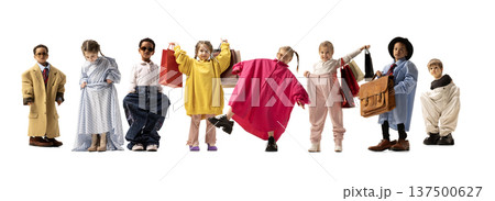 Kids posing with shopping bags and oversized clothes, symbolizing playful consumer culture and childhood imagination. Kids posing with shopping bags and oversized clothes, symbolizing playful consumer culture and childhood imagination. 137500627
