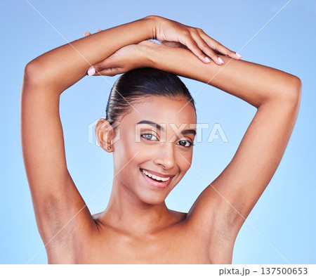 Armpit, hair removal and woman in portrait with beauty, grooming and smile isolated on blue background. Hygiene, cleaning body and epilation with skincare, cosmetics and dermatology in a studio 137500653