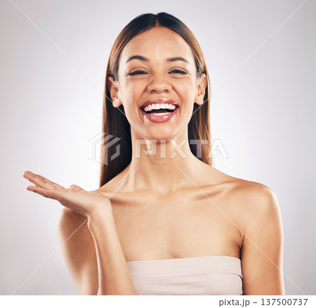 Portrait, woman and hand for beauty, skincare or advertising offer, space or mockup for marketing on white background in studio. Makeup, deal and smile on face for choice, cosmetics or palm for logo 137500737