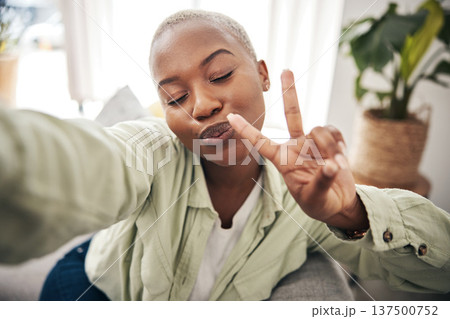 Woman, face and peace for selfie in home while live streaming vlog, post update or broadcast. Happy african content creator, profile picture or show v sign with hand emoji for social media influencer 137500752