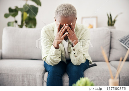 Woman, depression and crying on sofa for anxiety, mental health and stress of bad mistake at home. Doubt, sad and frustrated african person scared of trauma, headache and counselling of broken heart Woman, depression and crying on sofa for anxiety, mental health and stress of bad mistake at home. Doubt, sad and frustrated african person scared of trauma, headache and counselling of broken heart 137500876