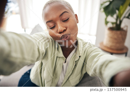 Home, face or black woman taking a selfie with a kiss or pout on sofa to post on social media. Apartment, house or African person taking a photo, vlog or picture on couch in living room to relax 137500945