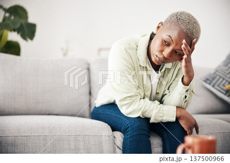 Woman, depression and thinking in home of pain, mental health or anxiety of debt, regret or risk. Stress, worry and frustrated african person with headache of sad trauma, broken heart or ptsd on sofa 137500966