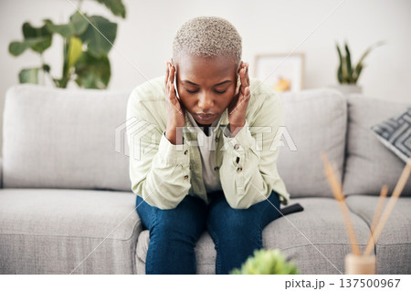 Anxiety, headache and pain with a black woman on a sofa in the living room of her home for mental health. Stress, burnout or vertigo and a young person in an apartment with depression or a migraine Anxiety, headache and pain with a black woman on a sofa in the living room of her home for mental health. Stress, burnout or vertigo and a young person in an apartment with depression or a migraine 137500967