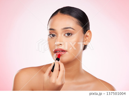 Woman, red and lipstick with beauty and makeup, cosmetics product in portrait isolated on pink background. Cosmetology, apply bold color to lips and shine, wellness and transformation in a studio Woman, red and lipstick with beauty and makeup, cosmetics product in portrait isolated on pink background. Cosmetology, apply bold color to lips and shine, wellness and transformation in a studio 137501004