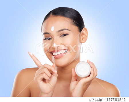 Portrait, happy woman and jar of cream in studio for aesthetic, skincare or advertising product on blue background. Model, beauty and moisturizer container of sunscreen, dermatology or face cosmetics Portrait, happy woman and jar of cream in studio for aesthetic, skincare or advertising product on blue background. Model, beauty and moisturizer container of sunscreen, dermatology or face cosmetics 137501242