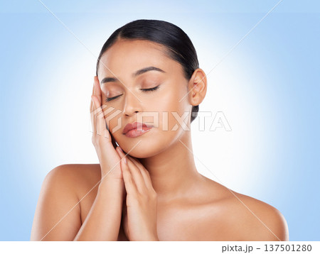 Skincare, beauty and woman with cosmetics, shine and dermatology on a blue studio background. Glow, person or model with luxury, self care or facial with aesthetic, soft or healthy skin with wellness 137501280