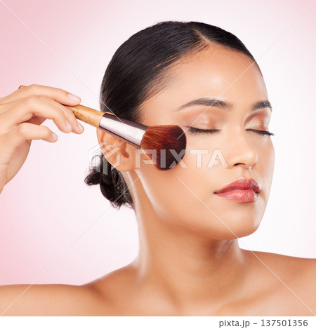 Beauty, brush and young woman in studio for facial foundation, glamour and makeup treatment. Cosmetics, self care and Indian female model with cosmetology face product isolated by pink background. Beauty, brush and young woman in studio for facial foundation, glamour and makeup treatment. Cosmetics, self care and Indian female model with cosmetology face product isolated by pink background. 137501356