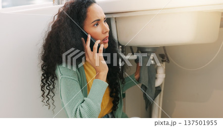 Sink repair, plumbing and woman on a phone call for maintenance, plumber service and home construction. Communication, manual labour and girl calling handyman for faucet problem, leak or kitchen pipe 137501955