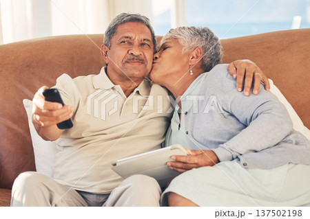 Kiss, TV and senior couple streaming movie or show with love, care and bonding in home living room together. Tablet, remote and elderly people relax and watching a subscription service on retirement Kiss, TV and senior couple streaming movie or show with love, care and bonding in home living room together. Tablet, remote and elderly people relax and watching a subscription service on retirement 137502198