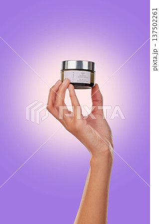 Hand, cream with beauty and skincare, advertising product with dermatology isolated on purple background. Person with cosmetics serum for skin and promotion, container and facial mask in studio Hand, cream with beauty and skincare, advertising product with dermatology isolated on purple background. Person with cosmetics serum for skin and promotion, container and facial mask in studio 137502261