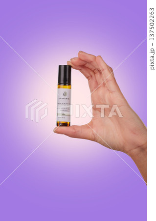 Hand, serum for lips with beauty and skincare, advertising product with dermatology isolated on purple background. Person with cosmetics for skin and promotion, bottle and wellness in a studio Hand, serum for lips with beauty and skincare, advertising product with dermatology isolated on purple background. Person with cosmetics for skin and promotion, bottle and wellness in a studio 137502263