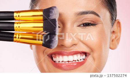 Face makeup, brush or happy woman with studio cosmetics tools, anti aging glow and closeup facial transformation. Foundation application product, happiness or aesthetic model smile on pink background Face makeup, brush or happy woman with studio cosmetics tools, anti aging glow and closeup facial transformation. Foundation application product, happiness or aesthetic model smile on pink background 137502274