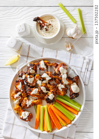 Alabama white sauce chicken wings with vegetables 137502282
