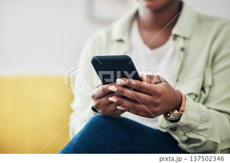 Hands of woman on sofa with phone, typing on social media and scroll on post or video online. Technology, internet and girl on couch with smartphone, digital app and like for viral content at home. Hands of woman on sofa with phone, typing on social media and scroll on post or video online. Technology, internet and girl on couch with smartphone, digital app and like for viral content at home. 137502346