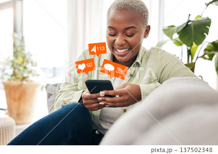 Notification, overlay and black woman with phone on sofa for social media, chat or emoji reaction at home. Smartphone, app and happy female influencer smile for online dating, blog or podcast content 137502348