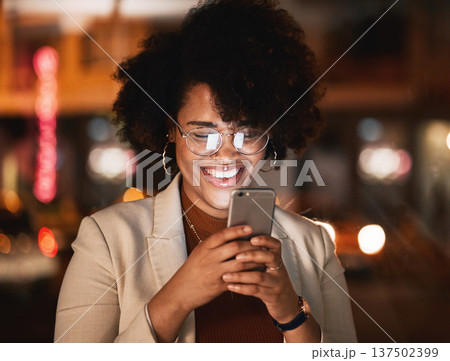 Reading, phone and African woman at night working in office with social media, meme or funny email or communication. Digital marketing, strategy and happy employee with online networking on cellphone Reading, phone and African woman at night working in office with social media, meme or funny email or communication. Digital marketing, strategy and happy employee with online networking on cellphone 137502399