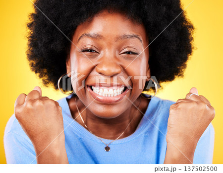 Black woman, face portrait and fist for success, celebrate promotion or winning lottery bonus on yellow background. Excited model, cheers or celebration of achievement, deal or lotto winner in studio Black woman, face portrait and fist for success, celebrate promotion or winning lottery bonus on yellow background. Excited model, cheers or celebration of achievement, deal or lotto winner in studio 137502500