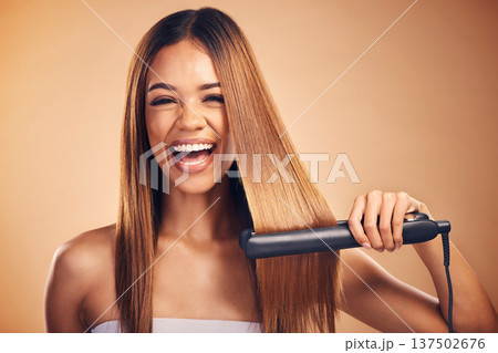 Happy, hair straightener and portrait of woman in studio for beauty, cosmetics or appliance. Excited person on brown background for heat treatment, healthy results and hairdresser or salon flat iron Happy, hair straightener and portrait of woman in studio for beauty, cosmetics or appliance. Excited person on brown background for heat treatment, healthy results and hairdresser or salon flat iron 137502676