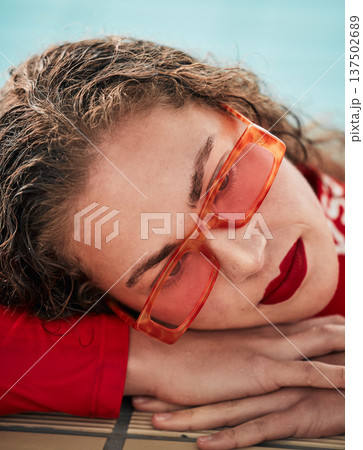 Face, summer and sunglasses with a hipster woman closeup in a swimming pool for safety or style. Fashion, thinking and poolside with a young swimmer looking bored waiting alone in trendy eyewear Face, summer and sunglasses with a hipster woman closeup in a swimming pool for safety or style. Fashion, thinking and poolside with a young swimmer looking bored waiting alone in trendy eyewear 137502689