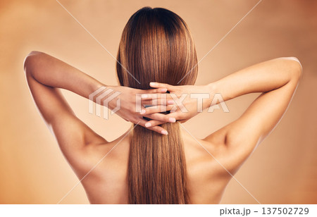 Studio, back and person with long hair care, healthy texture shine and strong extensions, cosmetic treatment or keratin results. Hairdressing spa, beauty salon and model hairstyle on brown background 137502729