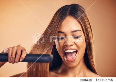 Excited, hair straightener and beauty of a woman in studio for cosmetics or mockup. Aesthetic model on brown background for wow heat treatment, healthy results and hairdresser or salon flat iron 137502790