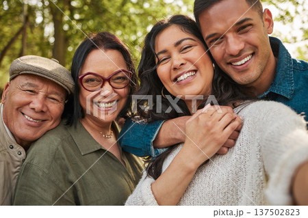 Happy family, parents and selfie by couple in a park together or people on vacation ans outdoor adventure. Smile, portrait and mother bonding with children and father in nature for summer travel 137502823