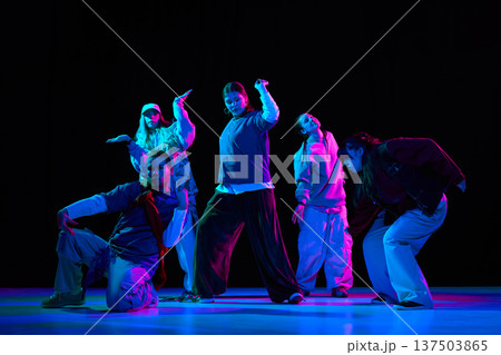 Hip hop dance performance with neon lighting and crew choreography, youth culture marketing campaigns 137503865