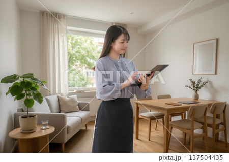 自宅でタブレットを操作する女性 自宅でタブレットを操作する女性 137504435