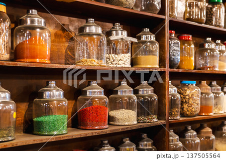 Traditional bedouin herbal pharmacy shelves with jars of medicinal herbs spices and natural remedies Traditional bedouin herbal pharmacy shelves with jars of medicinal herbs spices and natural remedies 137505564