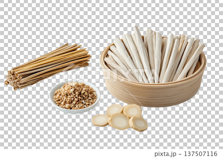 An assortment of dried Thai herbs and spices  including fragrant galangal slices  arranged in a wooden bowl alongside wooden sticks on a clean white background  This image showcases the natural 137507116