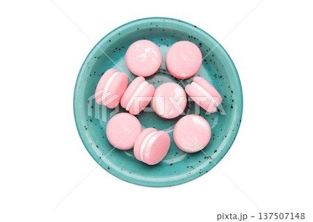 Pink macaroons in blue plate isolated on white background Pink macaroons in blue plate isolated on white background 137507148
