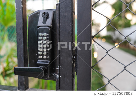 Electronic keypad door lock on metal gate for secure access control to private property Electronic keypad door lock on metal gate for secure access control to private property 137507808