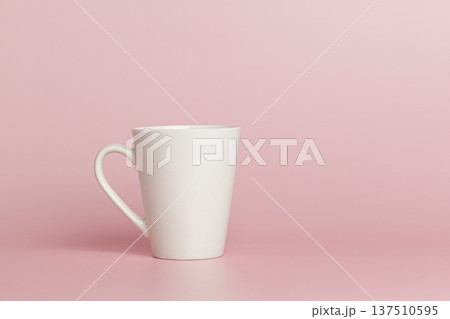 white cup for tea or coffee on a pink background 137510595