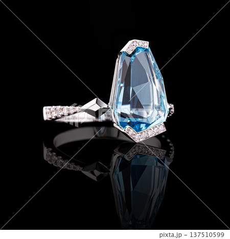 Beautiful white gold ring with diamonds and aquamarine on a black background Beautiful white gold ring with diamonds and aquamarine on a black background 137510599
