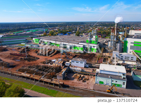 Woodworking plant, aerial view. Wood processing plant. Factory smoke stacks. Woodworking plant, aerial view. Wood processing plant. Factory smoke stacks. 137510724