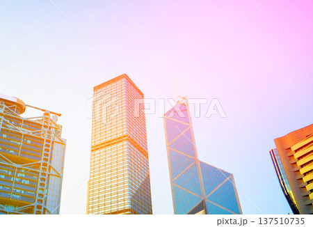 Skyscrapers in bright glass exteriors sunlight on sunset. Modern facade office buildings Skyscrapers in bright glass exteriors sunlight on sunset. Modern facade office buildings 137510735