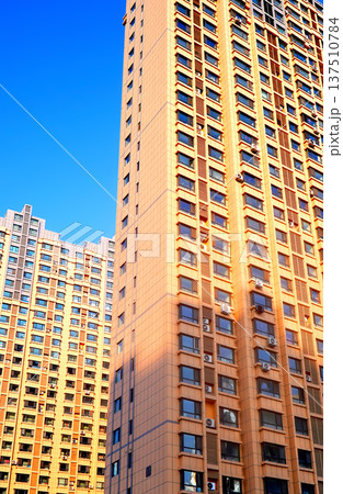 Glass tower building on blue sky background. Facade of new modern business office building. Glass tower building on blue sky background. Facade of new modern business office building. 137510784