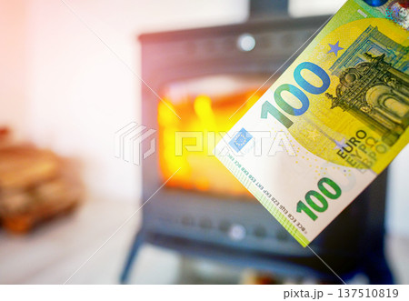Heating payment. Save money wood stove. Euro money banknotes for payment of heating firewood 137510819